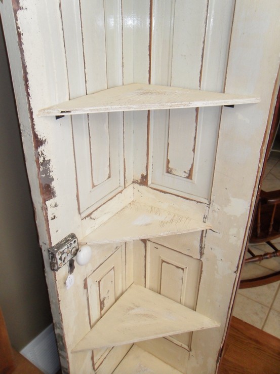 Corner shelf from an old door. Simply cut the door in half and add ...