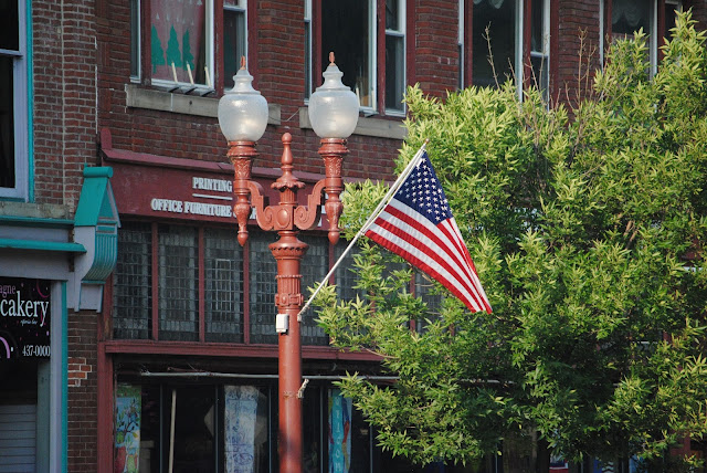 small town street with an american flag