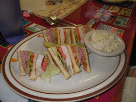 Roast beef and turkey club with coleslaw.