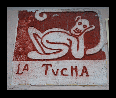 Merida Mexico neighborhood identifier sign featuring La Tucha the Monkey