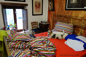 Dog in artist's BED Dogsitting while writing an art newsletter