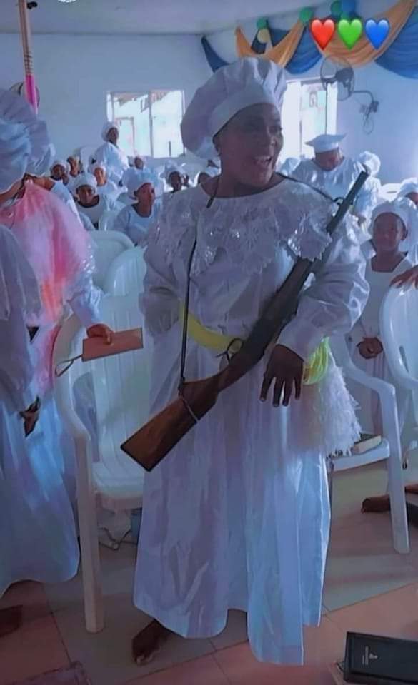Cele woman goes to church with her gun.