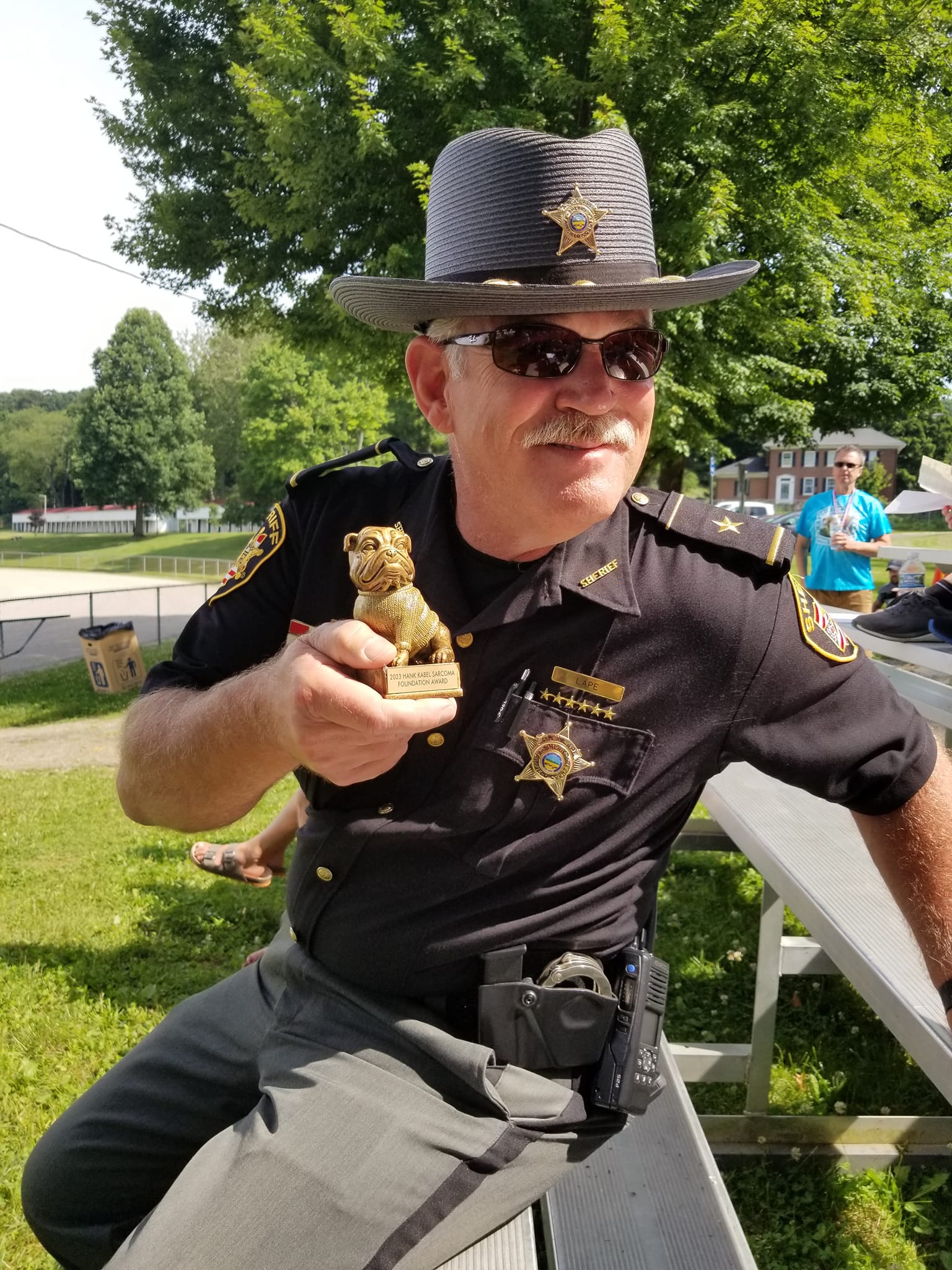 sheriff holding trophy