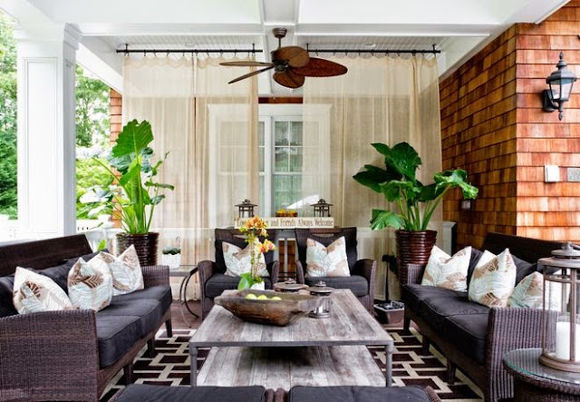 outside open porch lanai with brick fireplace geometric rug ceiling fan