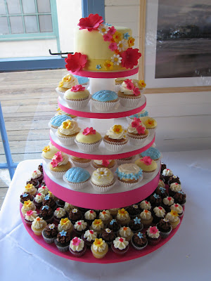 Spring wedding cupcake tower The top tier has a 6 inch cutting cake 