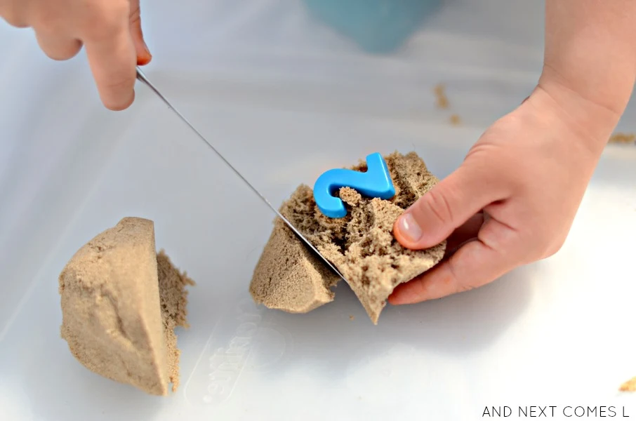 Number hunt activity for kids with kinetic sand that works on fine motor skills