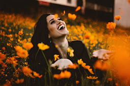 A joyful and happy person lying in a field of beautiful yellow flowers