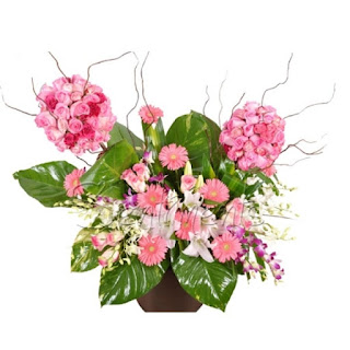 Unique double topiary arrangement of roses, gerberas and orchids in a basket.