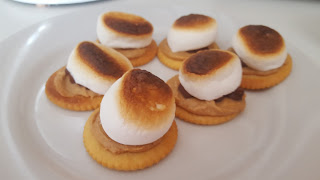 s'mores made with ritz crackers, marshmallows, chocolate and peanut butter