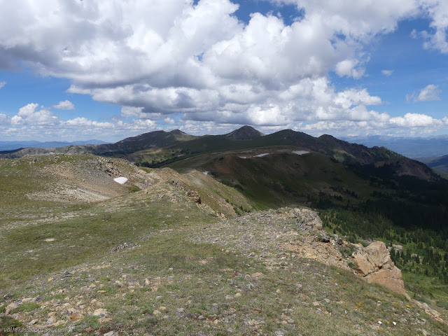 25: peaks under clouds