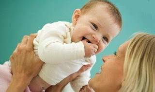 smiling baby and mother