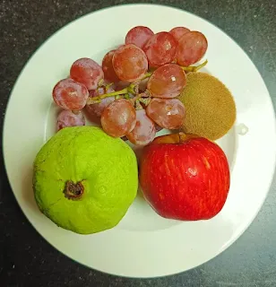 Apple, plum, grapes as a vegan food in plate