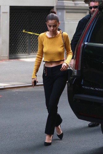 Selena Gomez ? Braless wearing a yellow sweater out in NYC