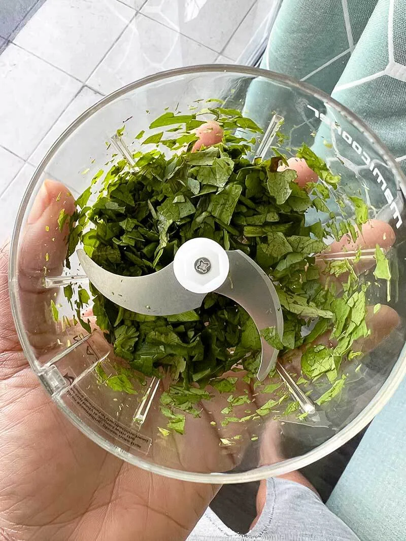 A grinder full of chadon beni leaves being prepared to store.