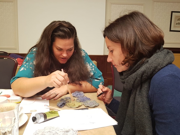 Rachele Carmona assisting Tatiana Kuprianchyk with a crochet design