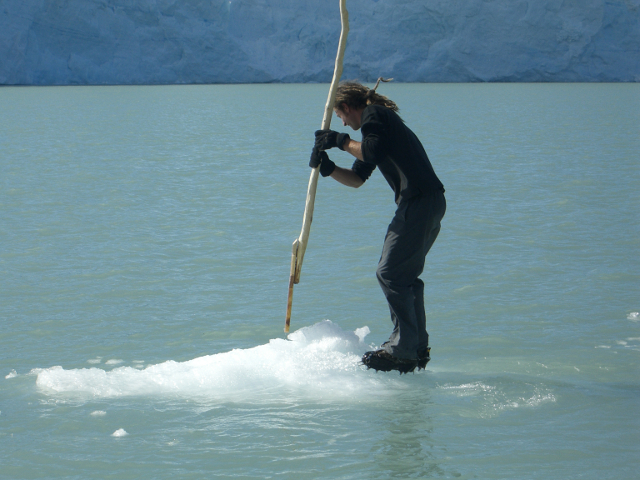 man rowing an iceberg on a lake in Patagonia