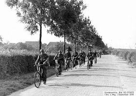 Bicycle mounted Waffen-SS Soldaten (SS Soldiers) ride towards "Arnhem", September 1944