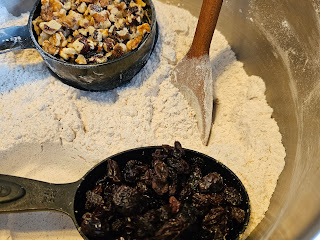 Dry ingredients in a bowl. Walnuts and raisins on top.