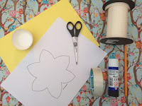 Craft items, including card, scissors, tape, cake cases, ribbon, pencil and glue