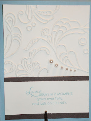 Front of pocketfold invitation featuring stamped sentiment dry embossed 