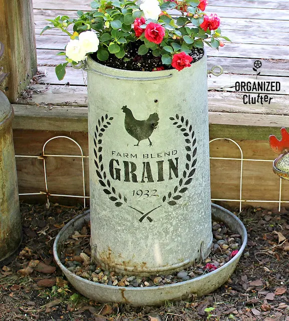 Photo of a chicken feeder planter upcycled with a farm stencil from Old Sign Stencils.