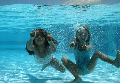 Image of 2 young girls underwater giving a thumbs up. Great Jobs for Good Swimmers