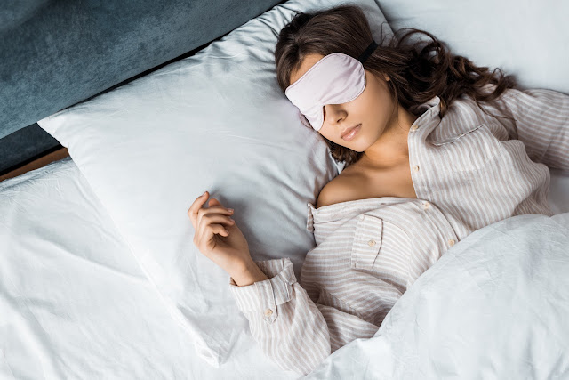 woman taking a nap with eye mask on