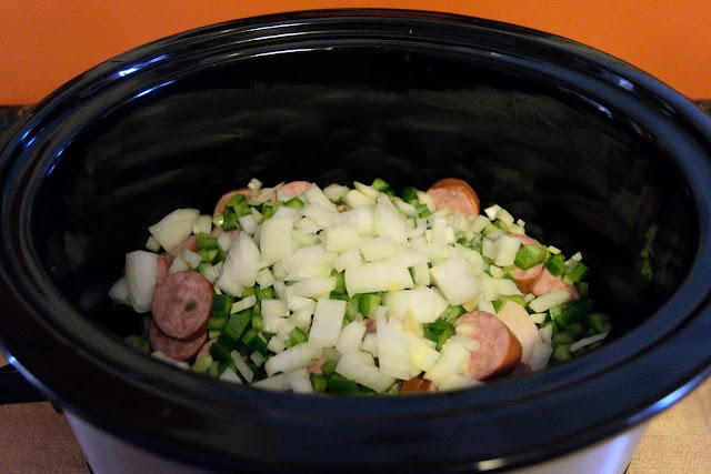 Onion, bell pepper, and garlic added to the crockpot.  