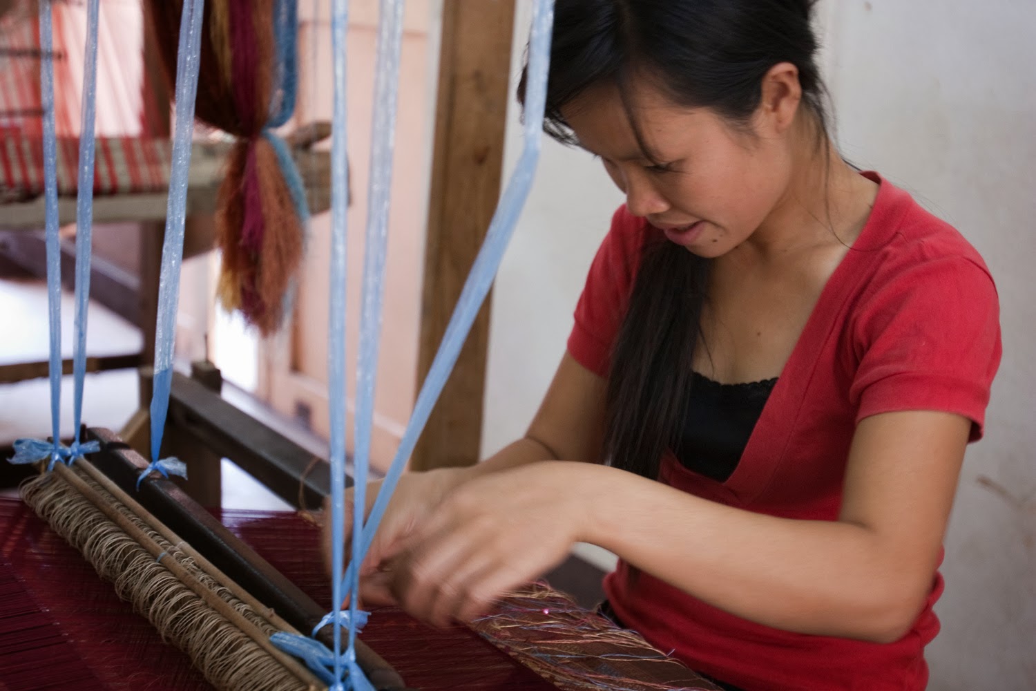 A young Lao weaver at the Houey Hong Vocational Training Centre for Women creates silk that reflects her culture and helps support her family.