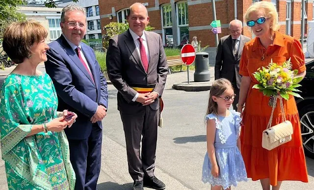 Princess Astrid wore a new orange belted midi dress by Marie Mero. Chanel two tone flats. King Albert I and Queen Elisabeth