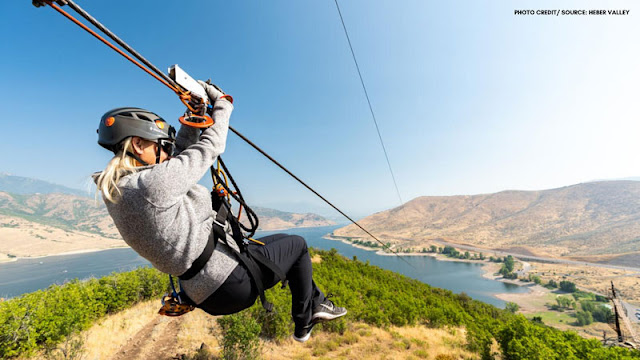 woman on zipline over water