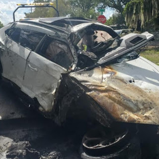 After being hit by another SUV, a Lamborghini goes airborne and catches fire as it lands.