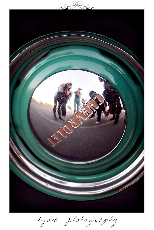 Photographers' reflection in a car wheel in Sausalito California