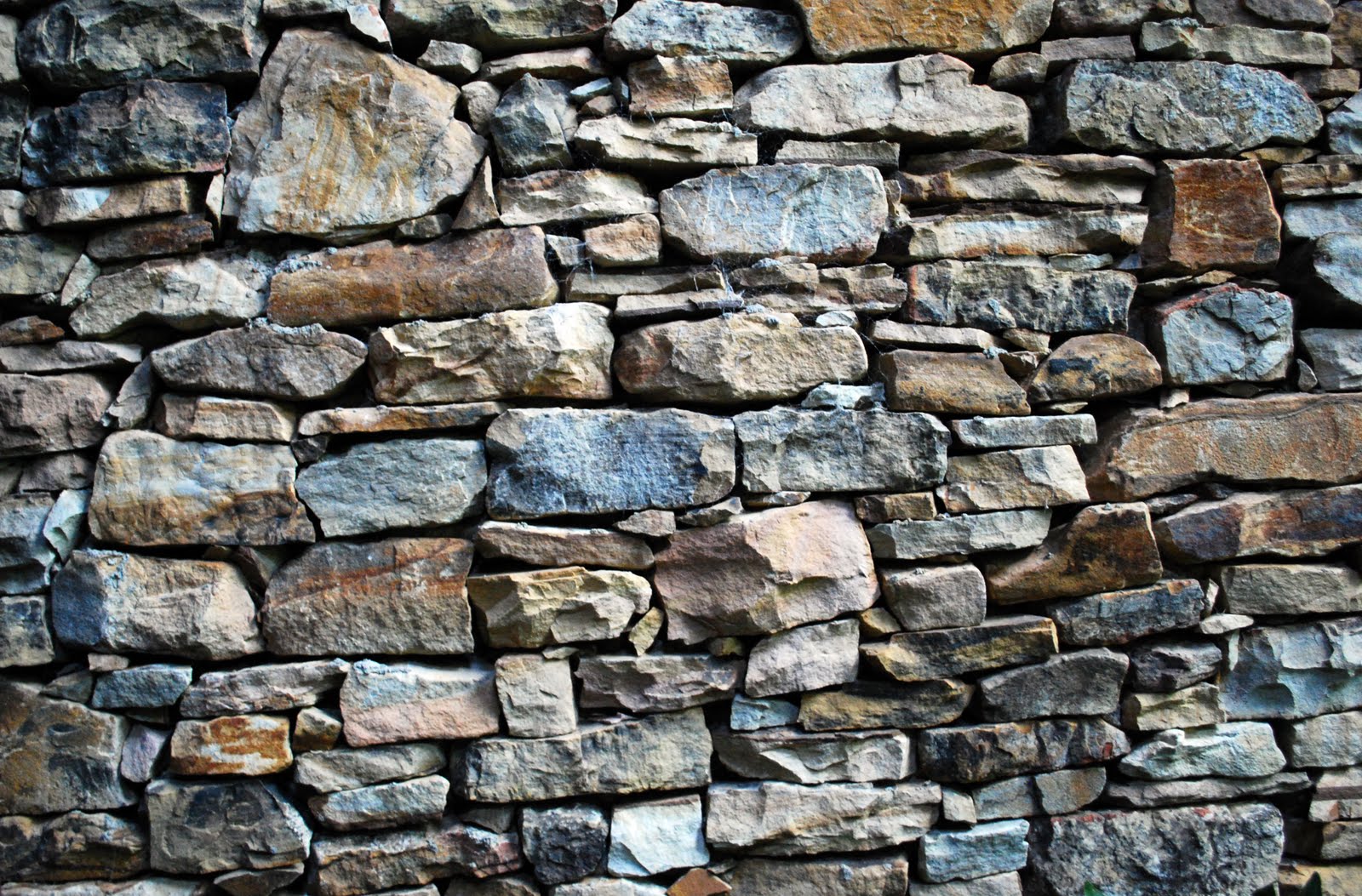 Lovely colors on this dry-stacked stone wall. The rusty orange with ...