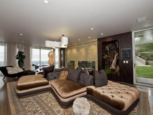 Picture of unusual shaped brown sofa in the modern living room of the guest house