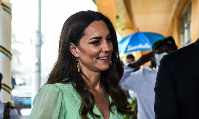 Kate Middleton wore a pleated chiffon midi dress by Self-Portrait, and gold maya earrings by Nadia Irena