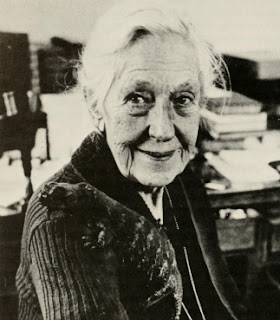 Doris Holmes Blake at her desk with her pet lizard on her shoulder