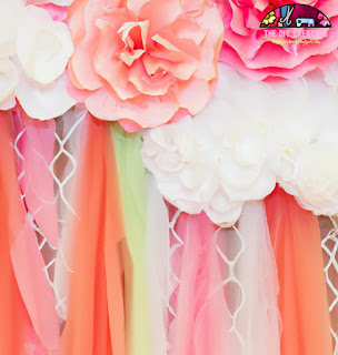 Image of a DIY backdrop made of tulle and paper flowers.