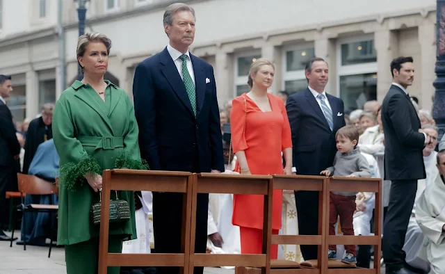Grand Duchess Maria Teresa wore a green wool coat by Natan. Princess Stephanie wore a coral Avatar dress by Natan
