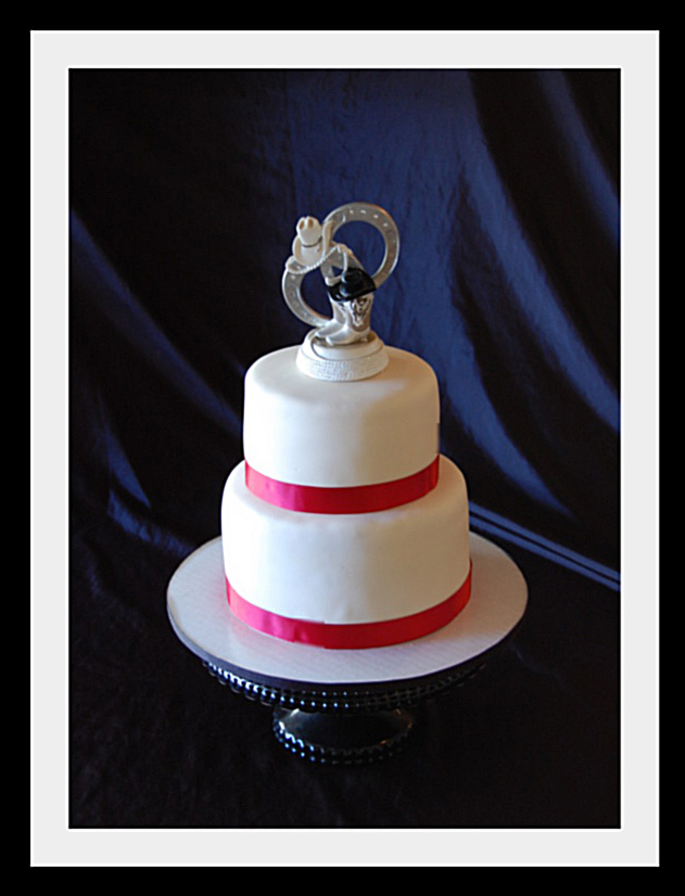 A 2 teir wedding cake with western topper An Alamo themed Anniversary cake 
