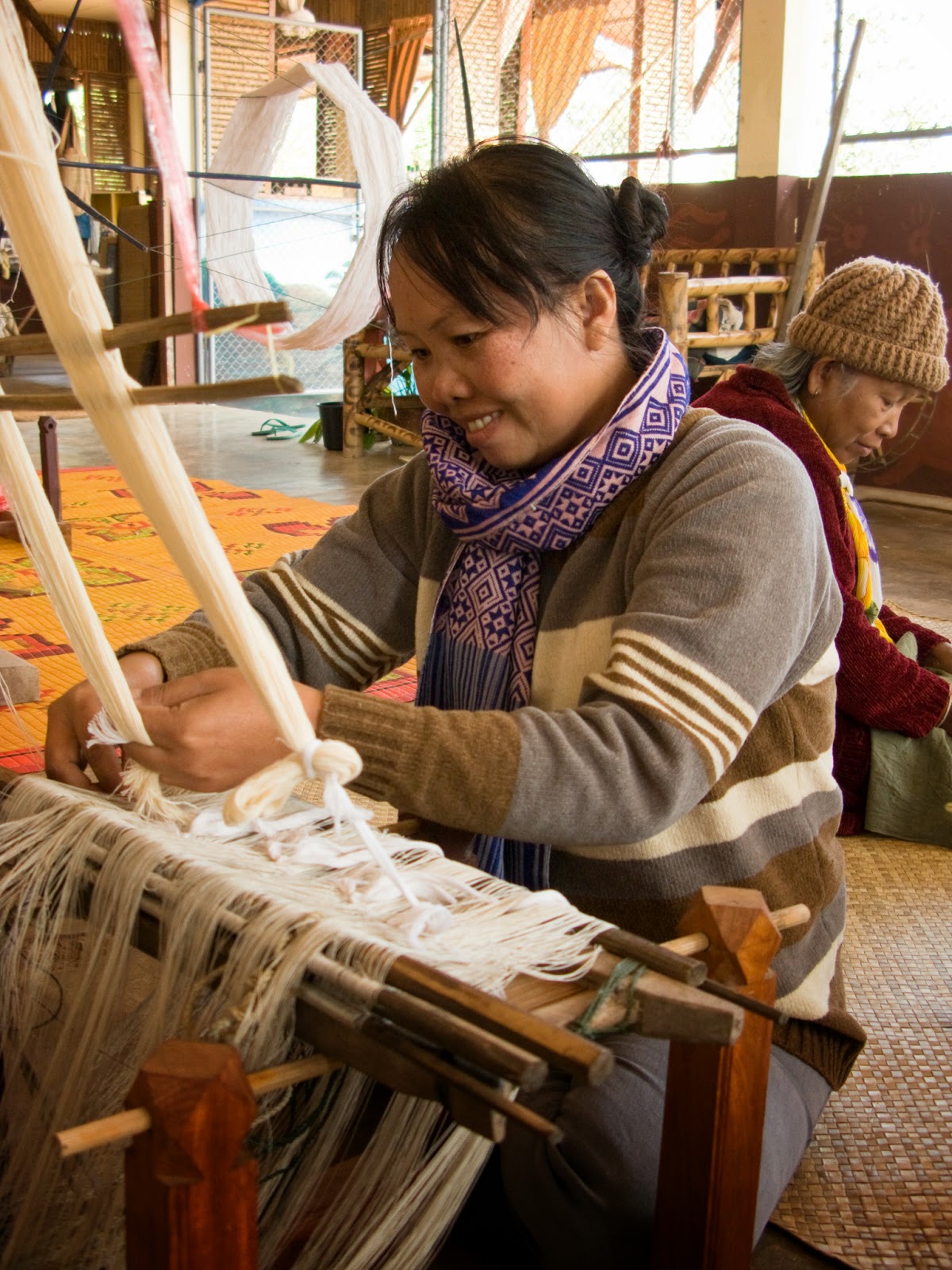 Cotton weavers, like silk weavers, usually work at home, but belonging to a weaving group allows Nuu Pun to receive training and other support.