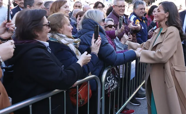 Queen Letizia wore a camel wool straight double-faced coat by Carolina Herrera, and green ranglan midi dress by Dandara