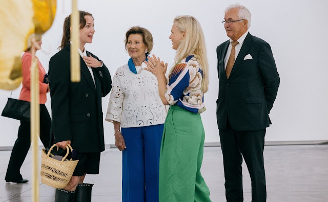 Queen Sonja wore a royal blue jumpsuit and white lace top. Hans Rasmus Astrup. Astrup Fearnley Collection