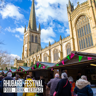 A series of log chalet stands serving a wide range of rhubarb-based treats and goodies, with Wakefield Cathedral in the background