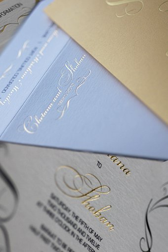 The Indian wedding invitation included a fold paper folio to carry the event 