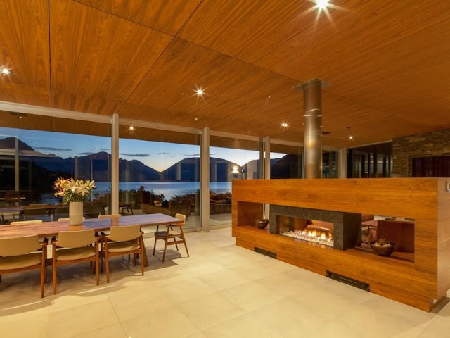 Wood and stone fireplace in the glass house 