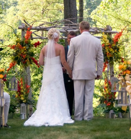 The talented groom made the wedding arch from tree branches found on his
