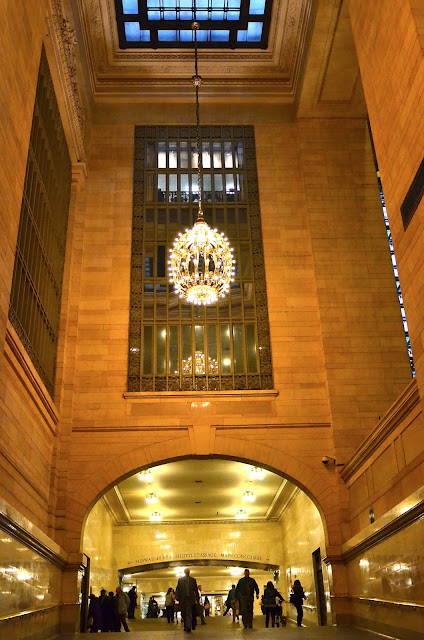 A beautiful chandelier hangs over one of Grand Central's marble arches.