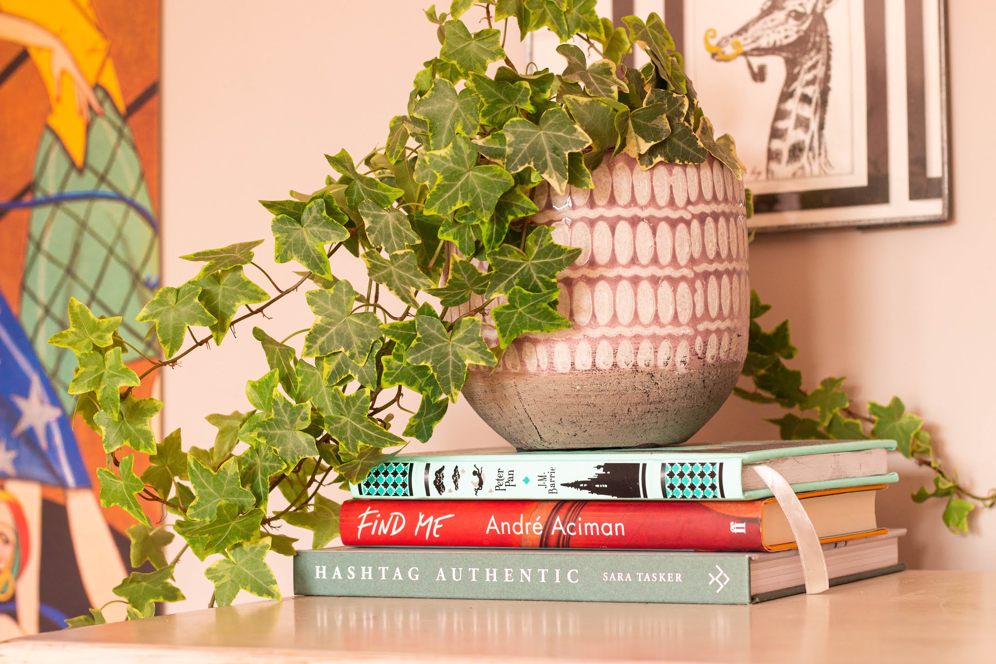 Bedroom details, plant, and books. Interior design and styling tips, 25% off Photowall Sweden Discount code