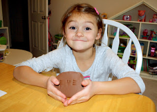 Tessa's cuneiform tablet with the word "fish" on it. We used tan FIMO clay that we baked hard in the oven.